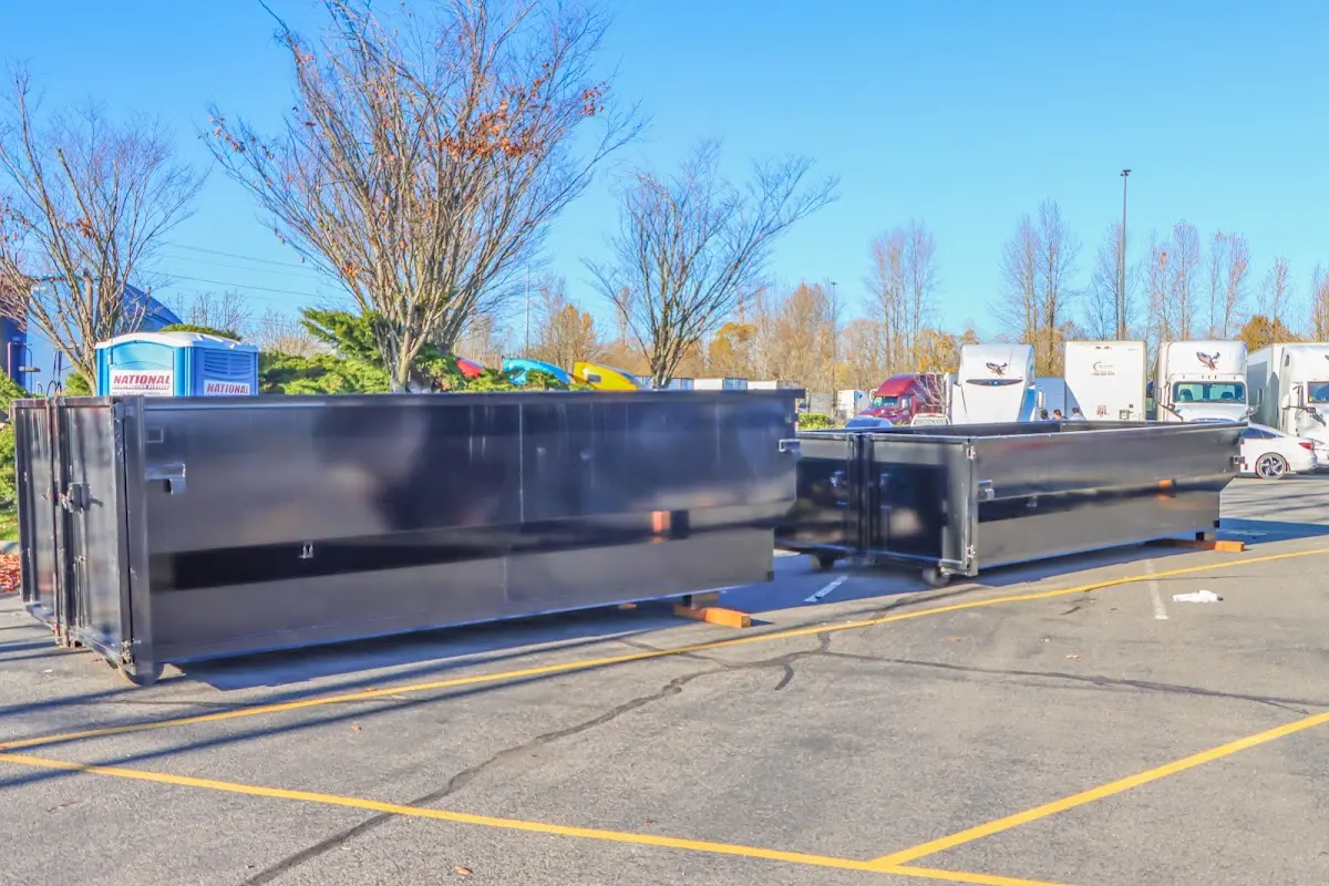 Professional dumpster rental service with roll-off container on residential driveway in Rutland